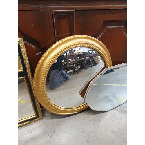 385 - An octagonal wall mirror, gilt framed oval mirror and gilt frames mirror with paiting to the top