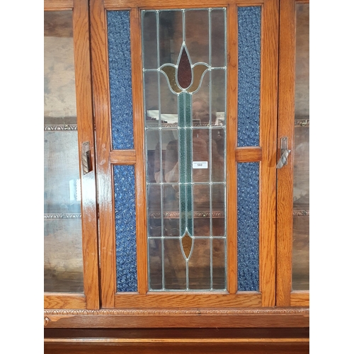 45 - An oak glazed topped Sideboard, the top with pair of glazed doors flanking central coloured glass pa... 