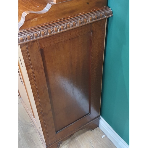 45 - An oak glazed topped Sideboard, the top with pair of glazed doors flanking central coloured glass pa... 