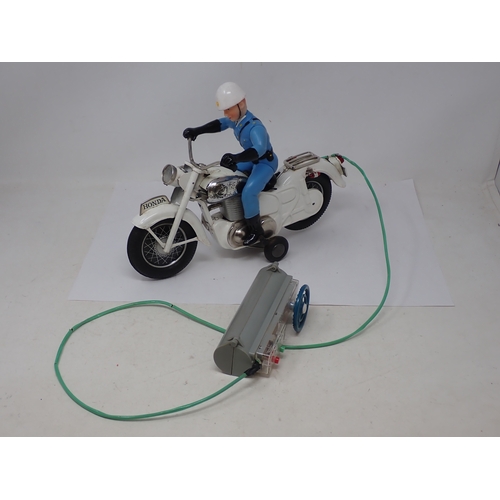 174 - A boxed Japanese Bandai battery operated remote control Police Auto Cycle