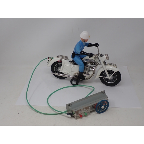 174 - A boxed Japanese Bandai battery operated remote control Police Auto Cycle