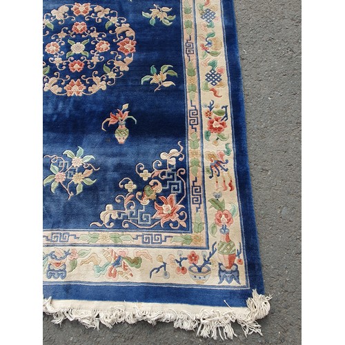 742 - A blue ground Chinese Rug with beige boarder decorated with a floral design, the central circular fl... 