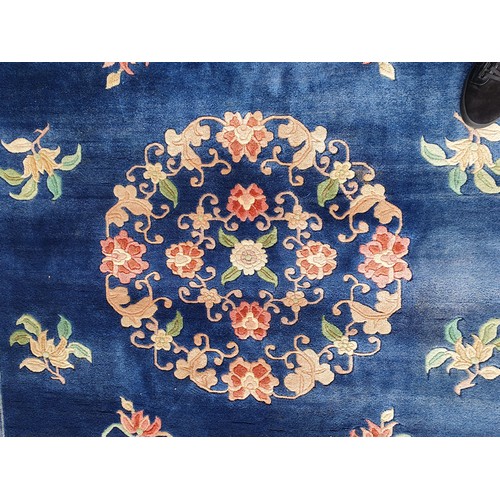 742 - A blue ground Chinese Rug with beige boarder decorated with a floral design, the central circular fl... 