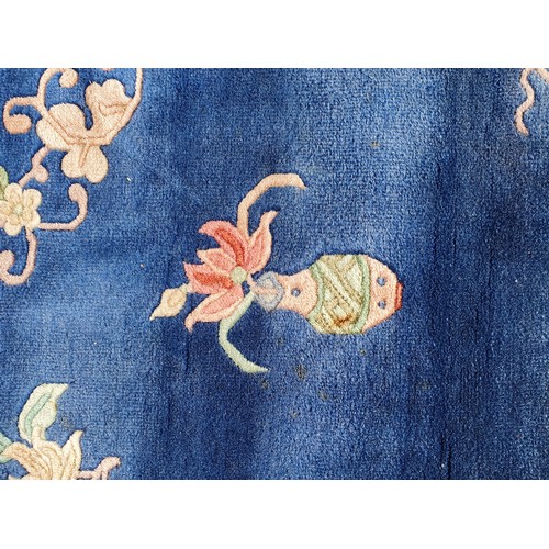 742 - A blue ground Chinese Rug with beige boarder decorated with a floral design, the central circular fl... 