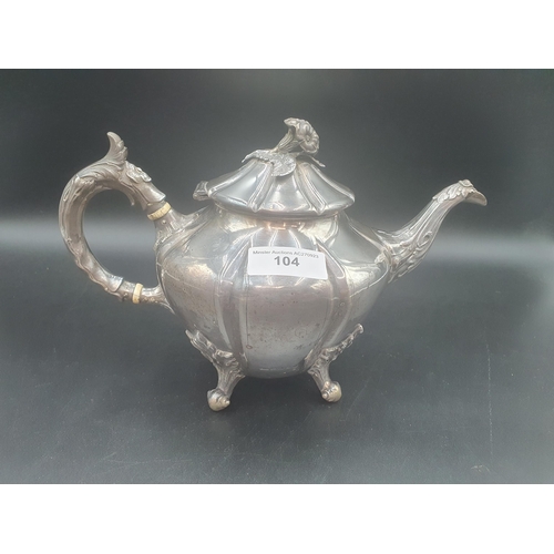 104 - A Victorian silver Teapot of panelled octagonal form, leafage scroll handle, spout and feet, flower ... 