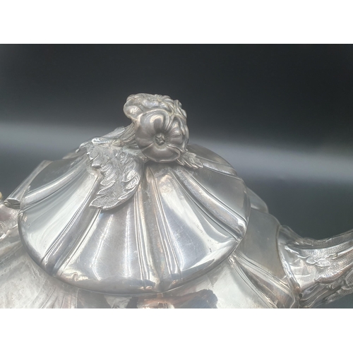 104 - A Victorian silver Teapot of panelled octagonal form, leafage scroll handle, spout and feet, flower ... 