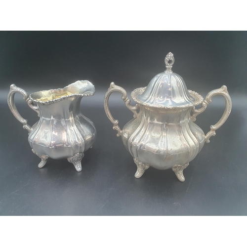 105 - A sterling silver two handled Sucrier and Cover and matching Jug on floral scroll supports, by Poole... 