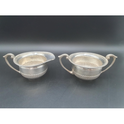 106 - A sterling silver two handled circular Sugar Bowl and Milk Jug, semi-fluted, 560 gms