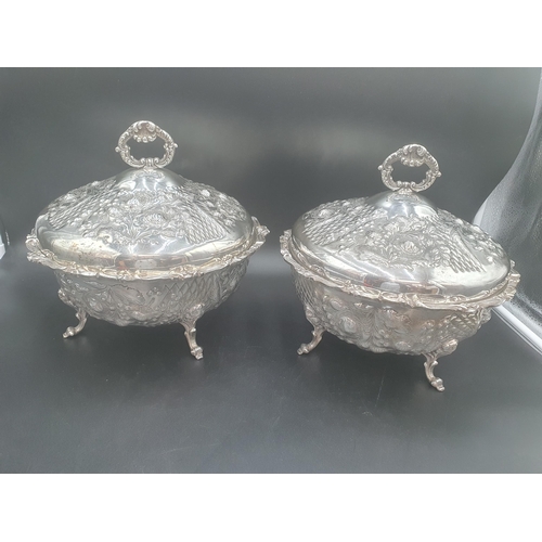 107 - A pair of plated circular Tureens and Covers floral embossed on scroll feet, 12in diam (R1)