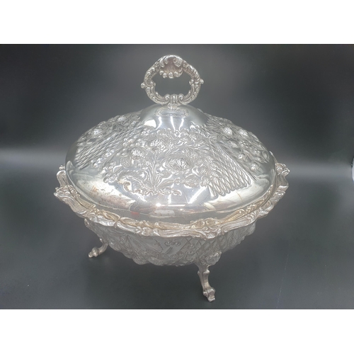 107 - A pair of plated circular Tureens and Covers floral embossed on scroll feet, 12in diam (R1)