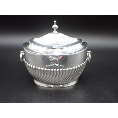 115 - A Victorian silver oval semi-fluted Tea Caddy with ring handles, camel crest and motto, London 1896