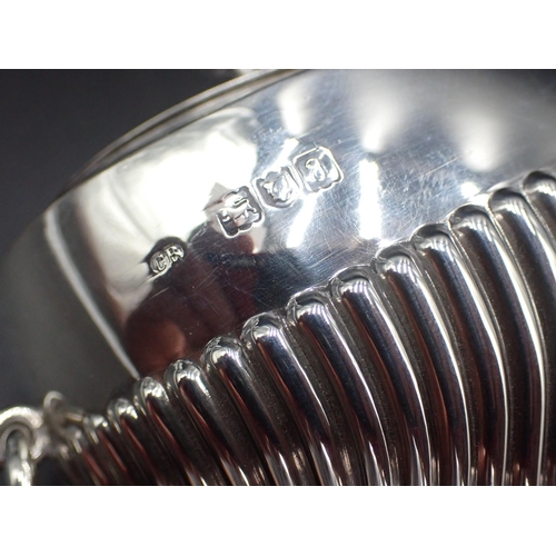 115 - A Victorian silver oval semi-fluted Tea Caddy with ring handles, camel crest and motto, London 1896