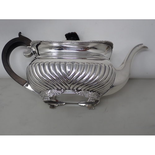 127 - A George V silver boat shape Teapot with gadroon embossing, gadroon and scallop rim on etruscan supp... 