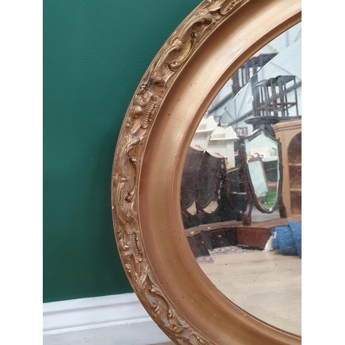 142 - A large oval gilt wall mirror