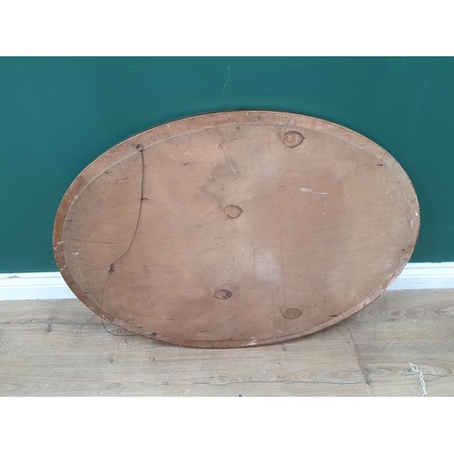 142 - A large oval gilt wall mirror