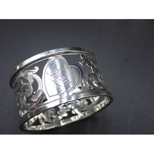 148 - A Victorian silver circular Napkin Ring engraved floral swags, Birmingham 1895, and four other silve... 