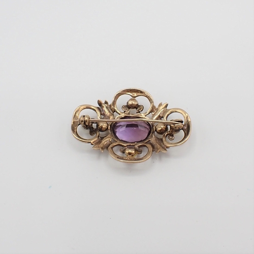 171 - An Amethyst and Cultured Pearl Brooch millegrain-set oval-cut amethyst in openwork foliate frame set... 