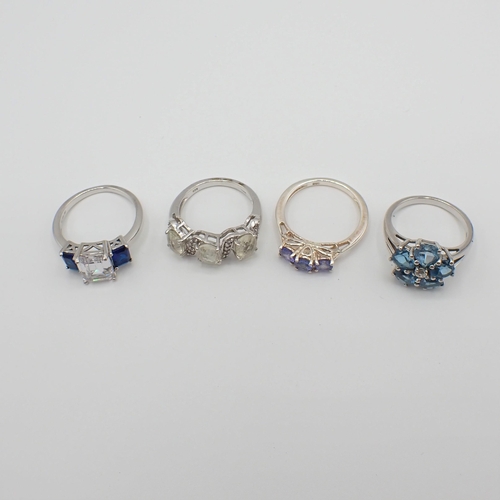 194 - Four silver Dress Rings set various stones