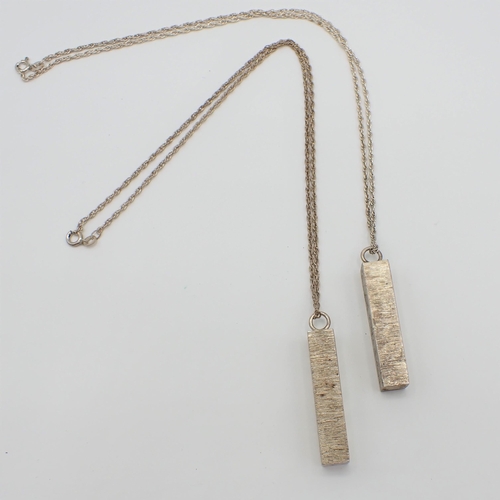 199 - Two silver Ingot Pendants on chains, commemorating Queen Elizabeth II silver jubilee