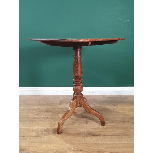 25 - An antique oak rectangular topped Tilt Top Tripod Table, on turned column support, 2ft 4