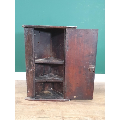 26 - An antique oak Hanging Corner Cupboard the single door enclosing two fitted shelves, 2ft 2