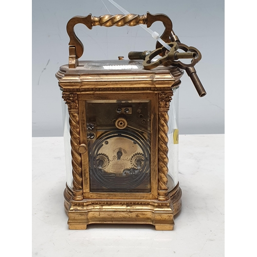 286 - A brass cased Carriage Clock with folding carrying handle above the white enamel rectangular dial ma... 