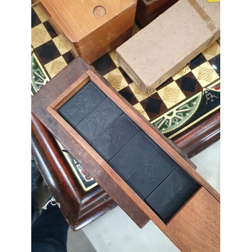 325 - A quantity of Chess Sets, Domino Sets and a framed glass Chess Board. (R5)