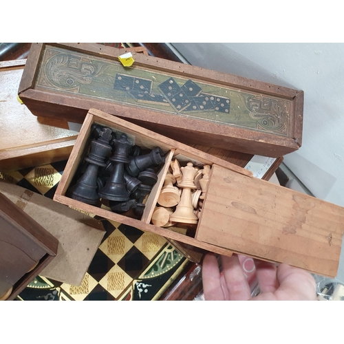 325 - A quantity of Chess Sets, Domino Sets and a framed glass Chess Board. (R5)