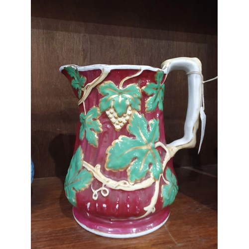 388 - A majolica Jug with ivy embossed and brick wall deign, 7in H, a porcelain Jug with elephant handle, ... 