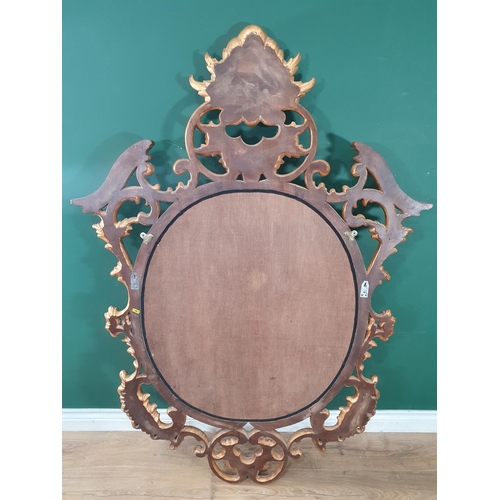 43 - A gilt painted Wall Mirror with bevelled plate with carved leafage and scrolled decorated frame, 5ft... 