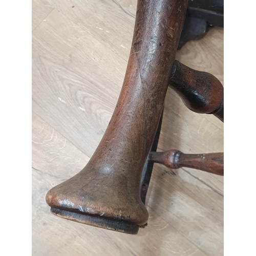 46 - A Georgian walnut corner Elbow Chair with red drop in seat mounted upon cabriole supports and pad fe... 