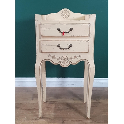 484 - A modern French Style cream painted Bedside Table with raised gallery, two fitted drawers, raised on... 