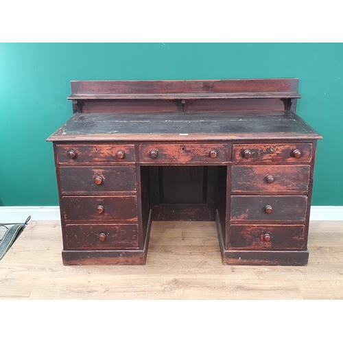 486 - A stained pine Kneehole Desk with raised backshelf, inset writing surface and nine fitted drawers, 3... 