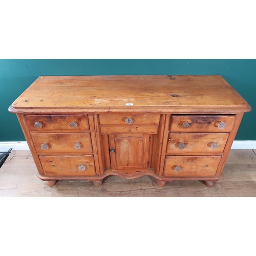 488 - A Victorian pine Dresser Base fitted seven drawers and single cupboard, raised on turned bun feet, 2... 