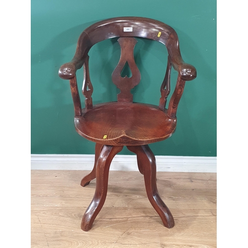 490 - A fruitwood and elm seated Armchair with pierced splats, shaped seat, raised on four shaped supports... 