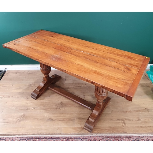 502 - An oak Refectory Table the rectangular plank top, raised on pair of turned column supports united by... 