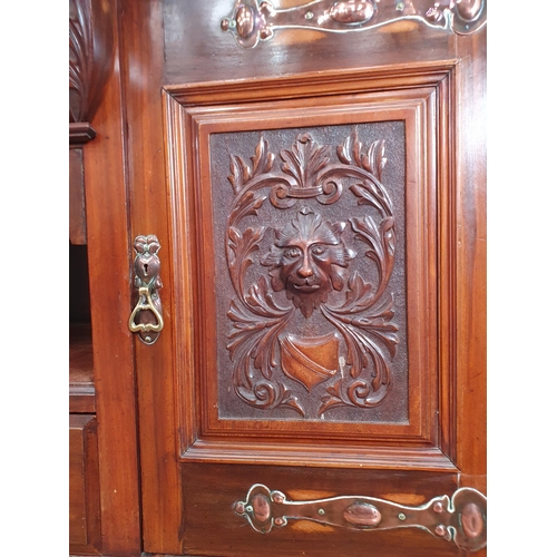 503 - An Art Nouveau Style walnut Sideboard with two central fitted drawers flanked by a pair of carved pa... 