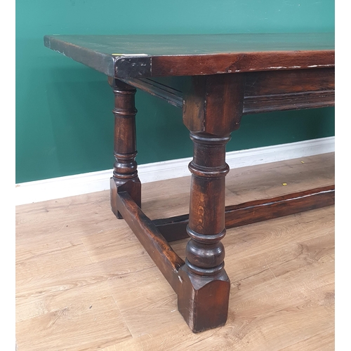 506 - A reproduction oak Refectory Table on turned supports united by central stretcher, 30