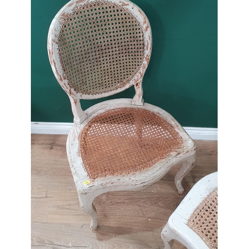 536 - A pair of white painted cane work Single Chairs. (R7).