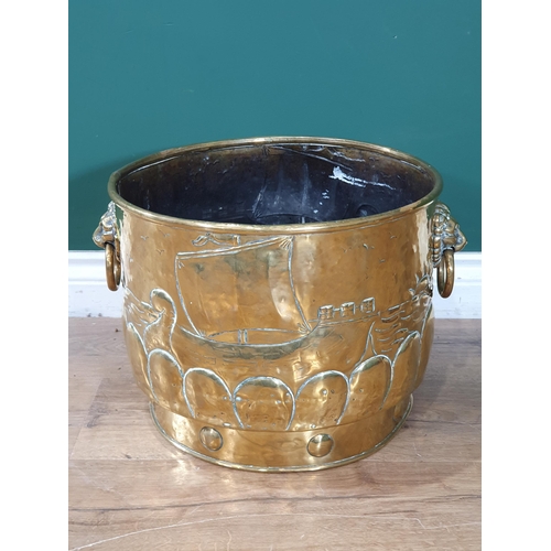 552 - An embossed brass two handled Log Bin with Viking ships at sea design, 14in Diam