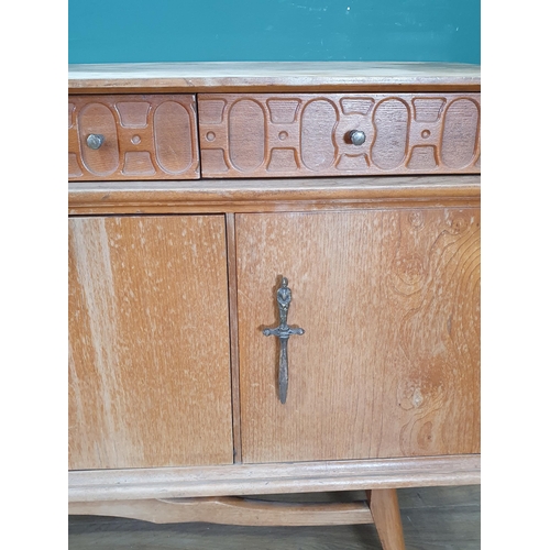 565 - A 20th Century hardwood Side Cabinet fitted three frieze drawers and two cupboard doors flanking fal... 