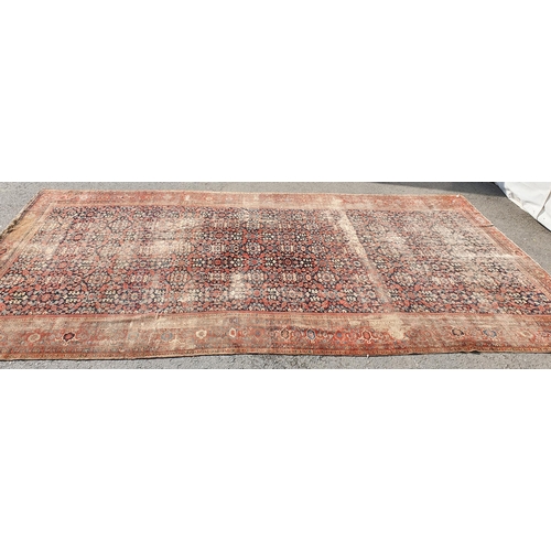 568 - A large Persian Carpet with multiple borders and design of floral motifs on a blue ground, 10ft 7in ... 