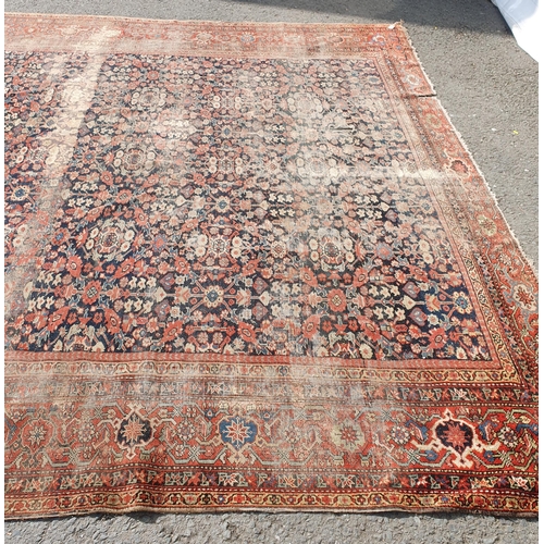 568 - A large Persian Carpet with multiple borders and design of floral motifs on a blue ground, 10ft 7in ... 