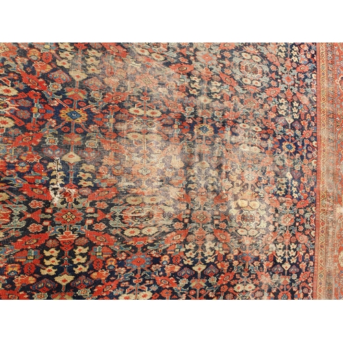 568 - A large Persian Carpet with multiple borders and design of floral motifs on a blue ground, 10ft 7in ... 