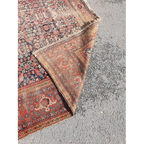 568 - A large Persian Carpet with multiple borders and design of floral motifs on a blue ground, 10ft 7in ... 