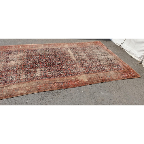 568 - A large Persian Carpet with multiple borders and design of floral motifs on a blue ground, 10ft 7in ... 