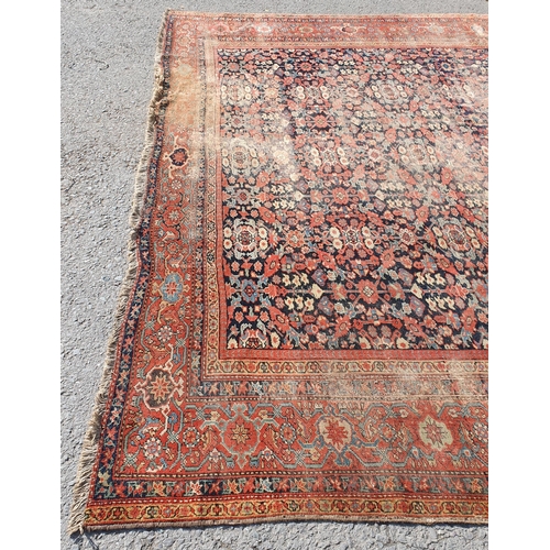 568 - A large Persian Carpet with multiple borders and design of floral motifs on a blue ground, 10ft 7in ... 