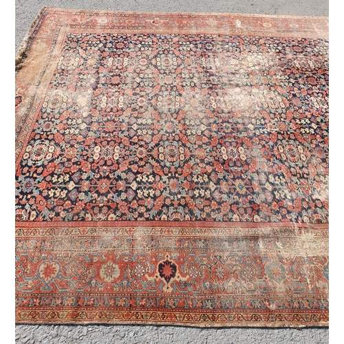 568 - A large Persian Carpet with multiple borders and design of floral motifs on a blue ground, 10ft 7in ... 