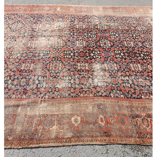 568 - A large Persian Carpet with multiple borders and design of floral motifs on a blue ground, 10ft 7in ... 