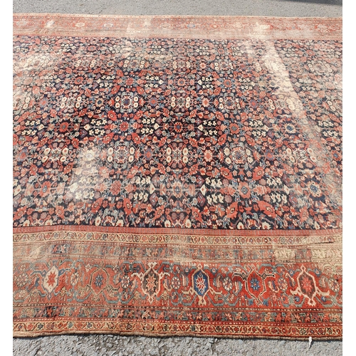 568 - A large Persian Carpet with multiple borders and design of floral motifs on a blue ground, 10ft 7in ... 